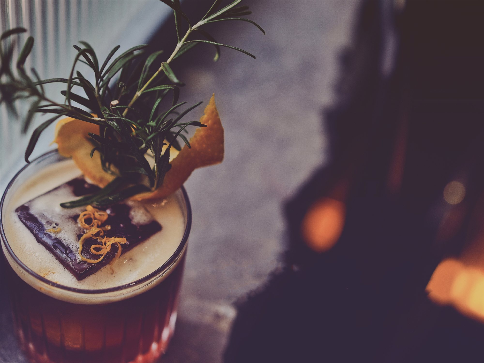 Cocktail crowned with rosemary and orange zest