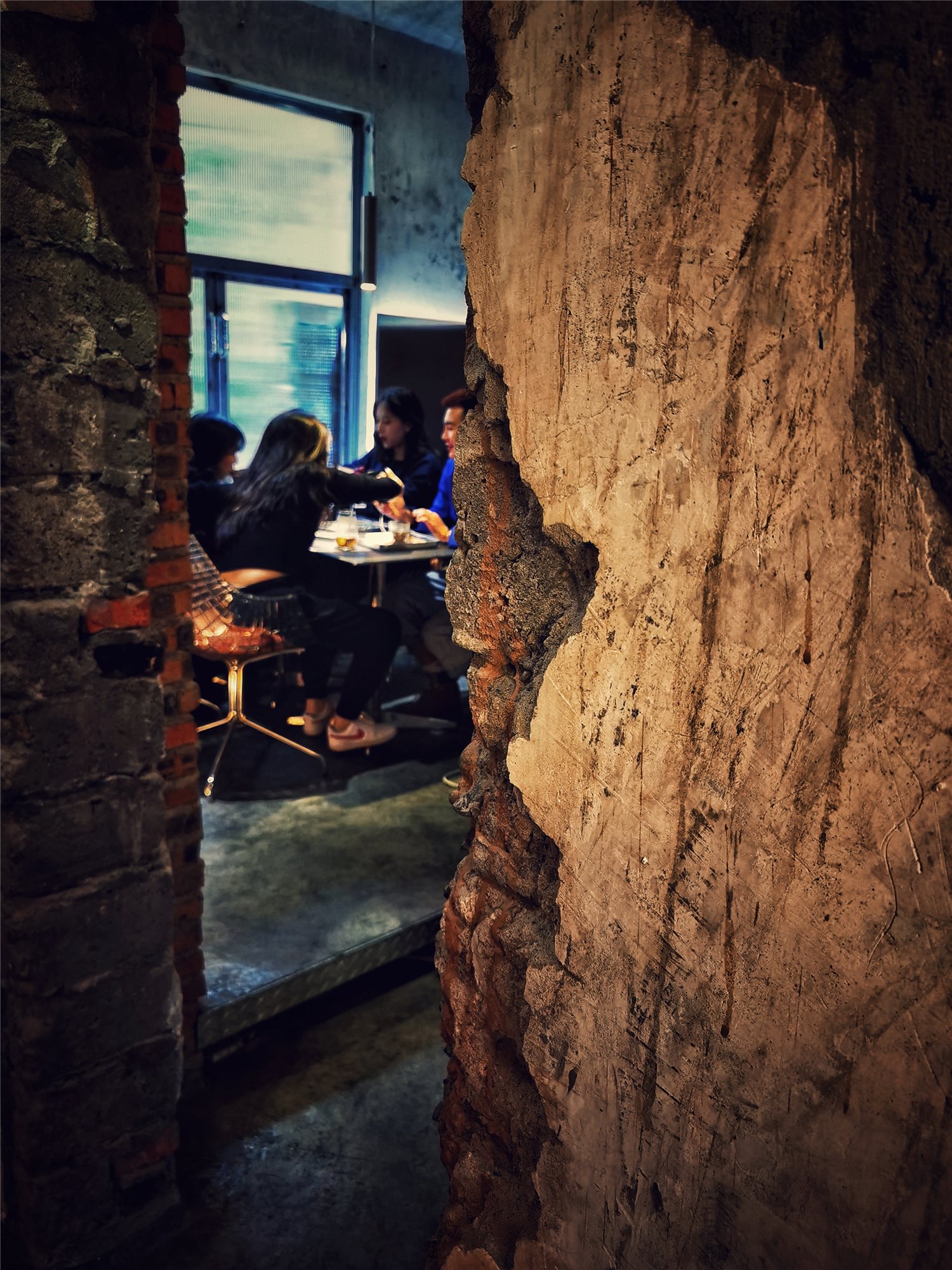 Guests seen through a gap in the ruined wall